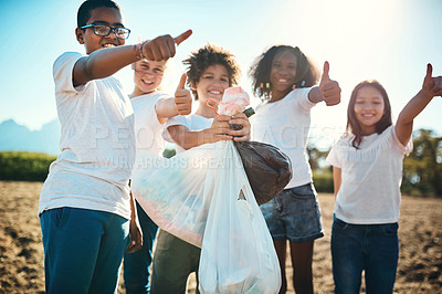 Buy stock photo Shot of a group of teenagers picking up litter off a field and showing thumbs up at summer camp