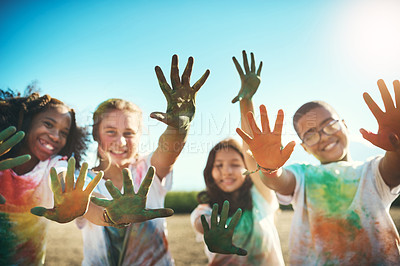 Buy stock photo Shot of a group of teenagers having fun with colourful powder at summer camp