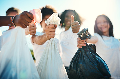 Buy stock photo Shot of a group of teenagers picking up litter off a field and showing thumbs up at summer camp