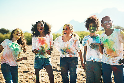 Buy stock photo Shot of a group of teenagers having fun with colourful powder at summer camp