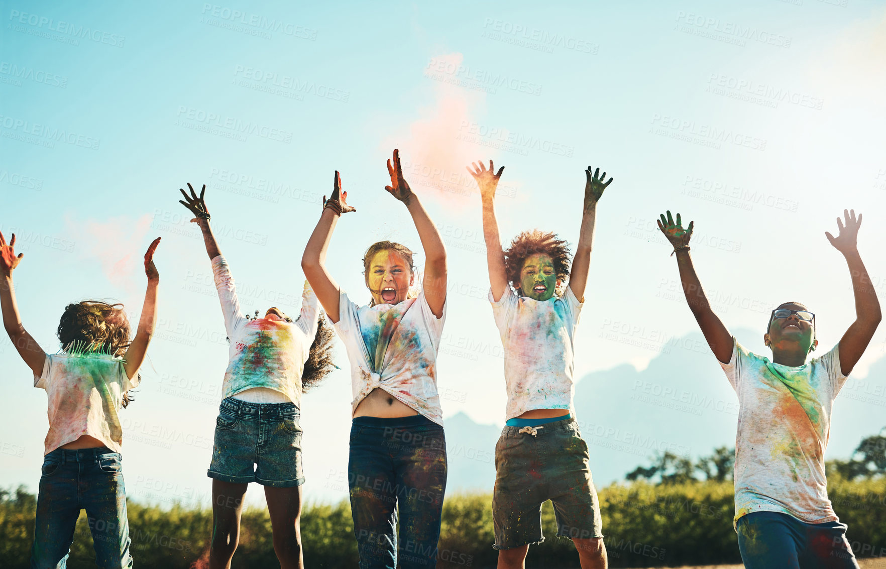 Buy stock photo Shot of a group of teenagers having fun with colourful powder at summer camp