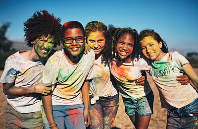 Buy stock photo Shot of a group of teenagers having fun with colourful powder at summer camp