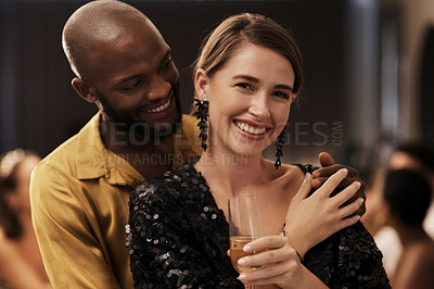 Buy stock photo Shot of a happy young couple standing close together during a New Year's eve dinner party