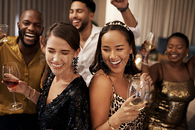 Buy stock photo Shot of a diverse group of friends dancing during a New Year's party at home