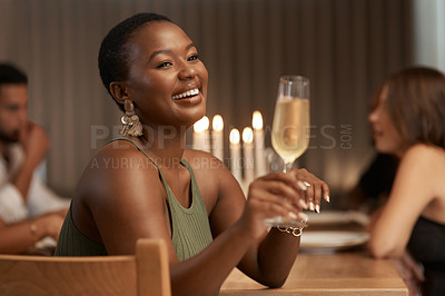 Buy stock photo Champagne, celebration and happy black woman at a party or dinner at a table in the dining room. Happiness, smile and African lady enjoying a glass of alcohol beverage at a new year event at a house.