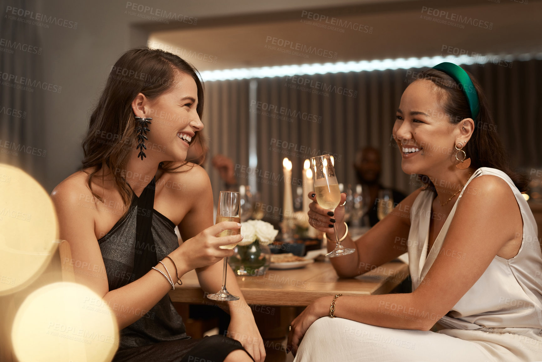 Buy stock photo Friends, champagne and women in restaurant, party and dinner for bonding. New Years, females and girls enjoy drink, smile and conversation for celebration, bond and happy at social event to relax.