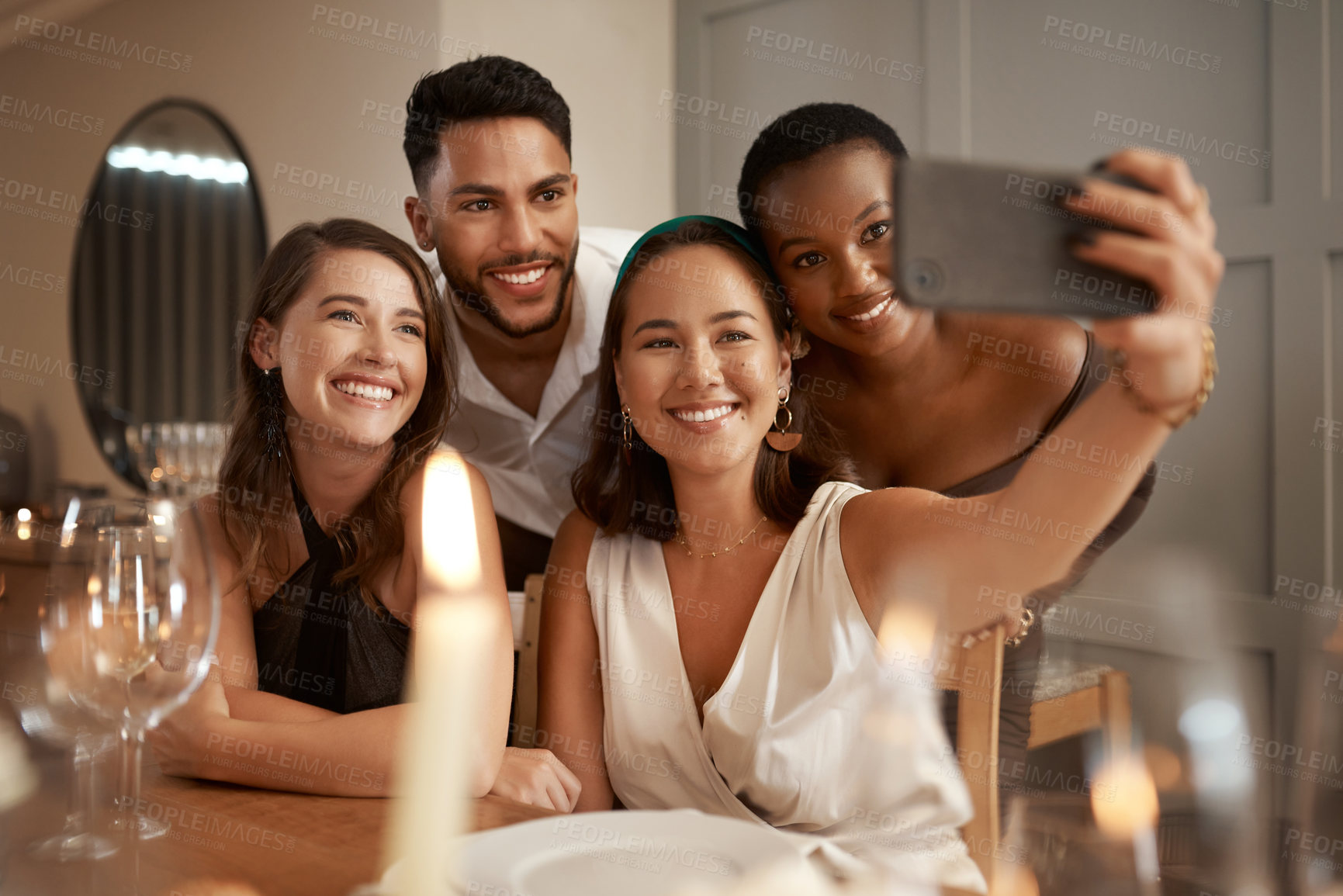 Buy stock photo Friends, phone selfie and dinner party, social media and communication in home for new year celebration and happy smile. Diversity and picture for internet post  at night or holiday event with group