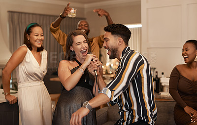 Buy stock photo Friends, party and karaoke night at the house for fun social event or gathering together in celebration for new year. Happy people celebrating friendship, birthday or festive season singing at home