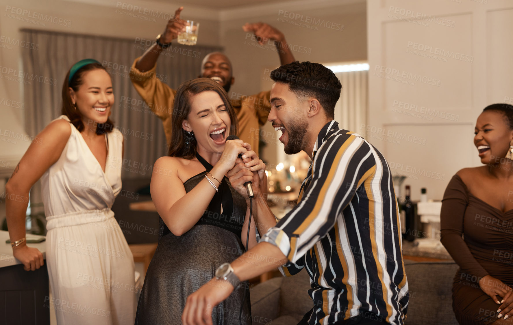 Buy stock photo Friends, party and karaoke night at the house for fun social event or gathering together in celebration for new year. Happy people celebrating friendship, birthday or festive season singing at home