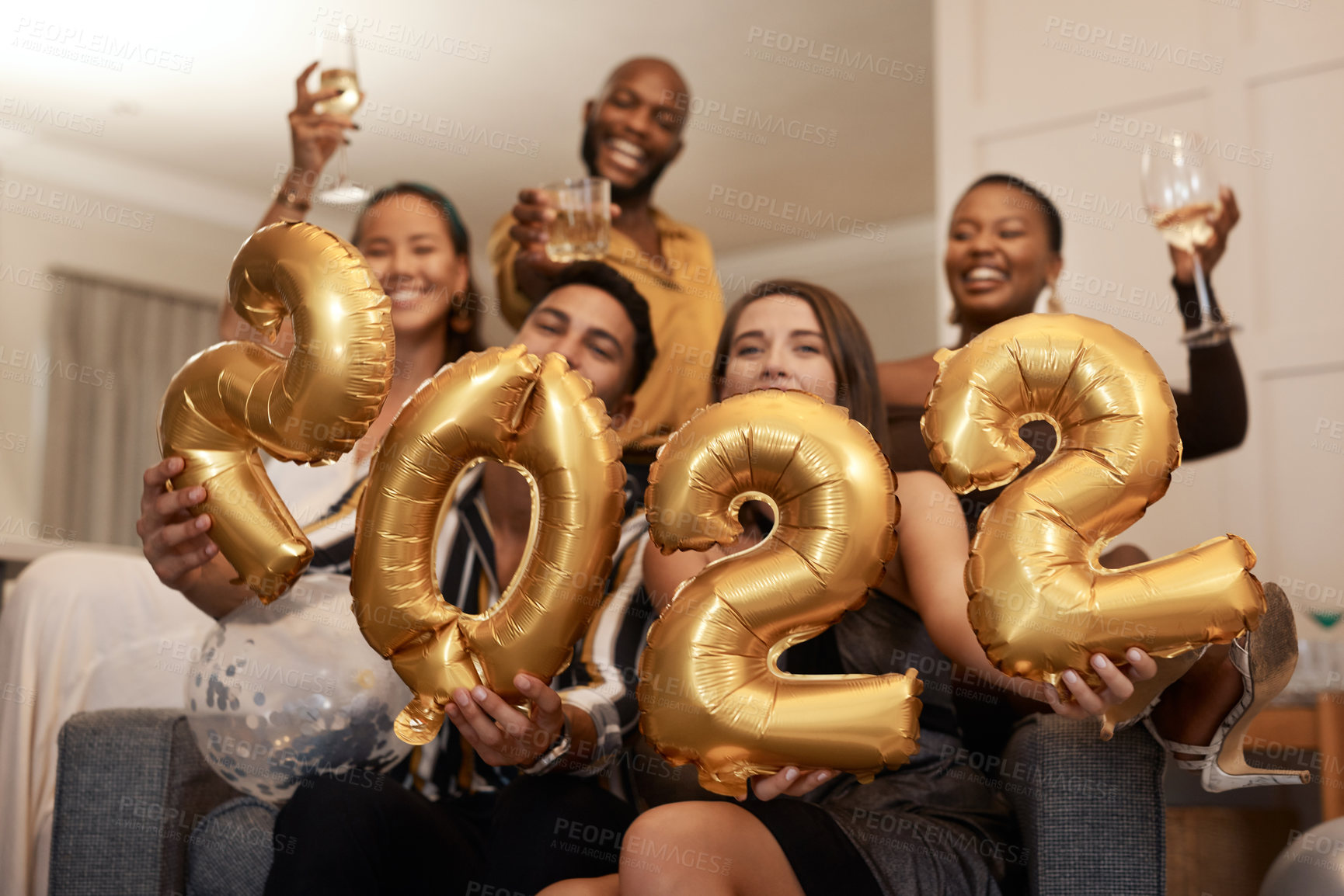 Buy stock photo Happy, friends and new year with 2022 balloons at festive party, celebration and social gathering. People, decoration or cheers with alcohol at reunion, bonding and get together for milestone in home