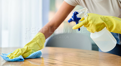 Buy stock photo Shot of an unrecognizable person wiping a surface at home