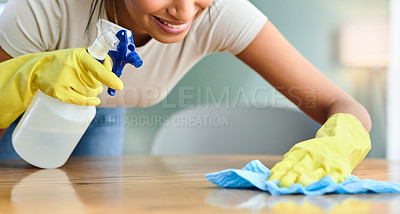 Buy stock photo Shot of a young woman wiping a surface at home