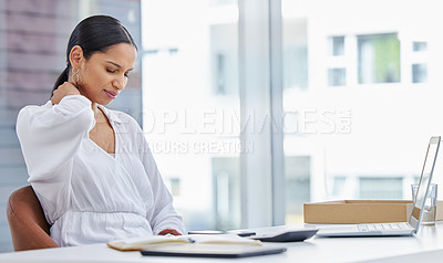 Buy stock photo Shot of a young businesswoman sitting at a desk feeling strain in her neck in a modern office