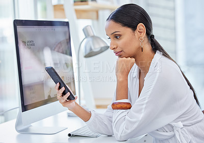 Buy stock photo Shot of a young businesswoman scrolling on her cellphone in a modern office