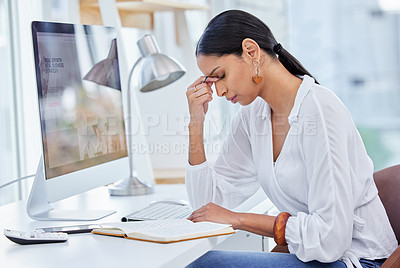 Buy stock photo Shot of a young businesswoman sitting at a desk looking overwhelmed in a modern office