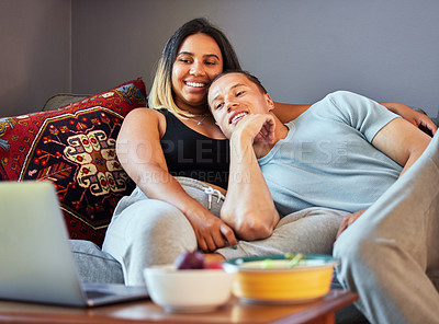 Buy stock photo Shot of a couple watching a video on a laptop at home