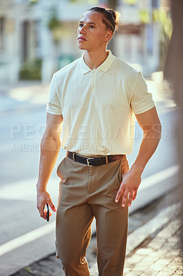 Buy stock photo Shot of a young man walking in the city