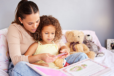 Buy stock photo Reading, book and storytelling with mother with daughter in bedroom for fairytale, fantasy or creative. Education, learning and love with woman and girl in family home for study, literature and relax