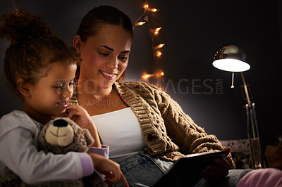 Buy stock photo Mother, girl child and tablet in bed, comfort and storytelling for bed time routine, bonding and love at family home. Woman, daughter and together in bedroom at night with ebook, safety and security