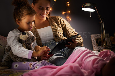 Buy stock photo Mother, girl kid and tablet in bed, comfort and storytelling for bed time routine, bonding and love at family home. Woman, daughter and together in bedroom at night with ebook, safety and security