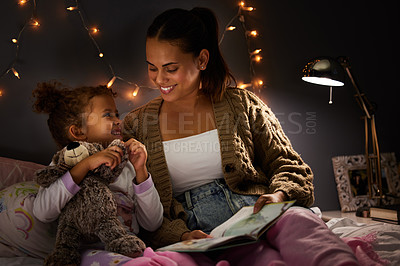 Buy stock photo Night, book and  learning with mother with daughter in bedroom for storytelling, fantasy and smile. Education, fairytale and love with woman reading to girl in family home for bedtime, happy or relax