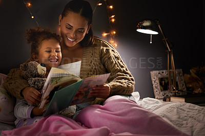 Buy stock photo Night, book and mother with daughter in bedroom for storytelling, fantasy and creative. Education, learning and love with woman reading to young girl in family home for bedtime, literature and relax