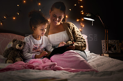 Buy stock photo Woman, girl child and tablet in bed, comfort and storytelling for bed time routine, bonding and love at family home. Mother, daughter and together in bedroom at night with ebook, safety and security