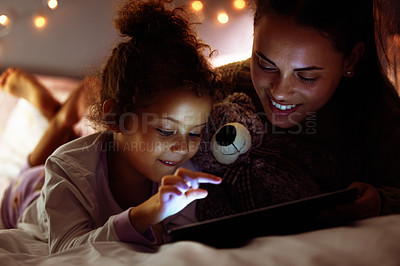 Buy stock photo Woman, girl kid and tablet in bed, storytelling or watch cartoon at bed time with bonding and love at family home. Mother, daughter and together in bedroom at night with ebook, games or movie