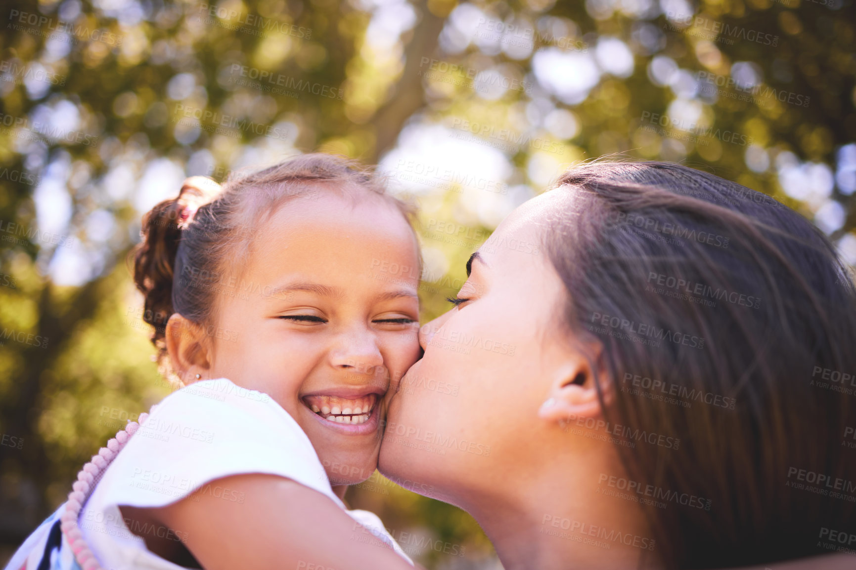 Buy stock photo Girl, mother and kiss cheek in nature, funny and bonding on summer holiday vacation. Mom, kissing and happy child, love and affection, care and enjoying quality family time together outdoor in park.