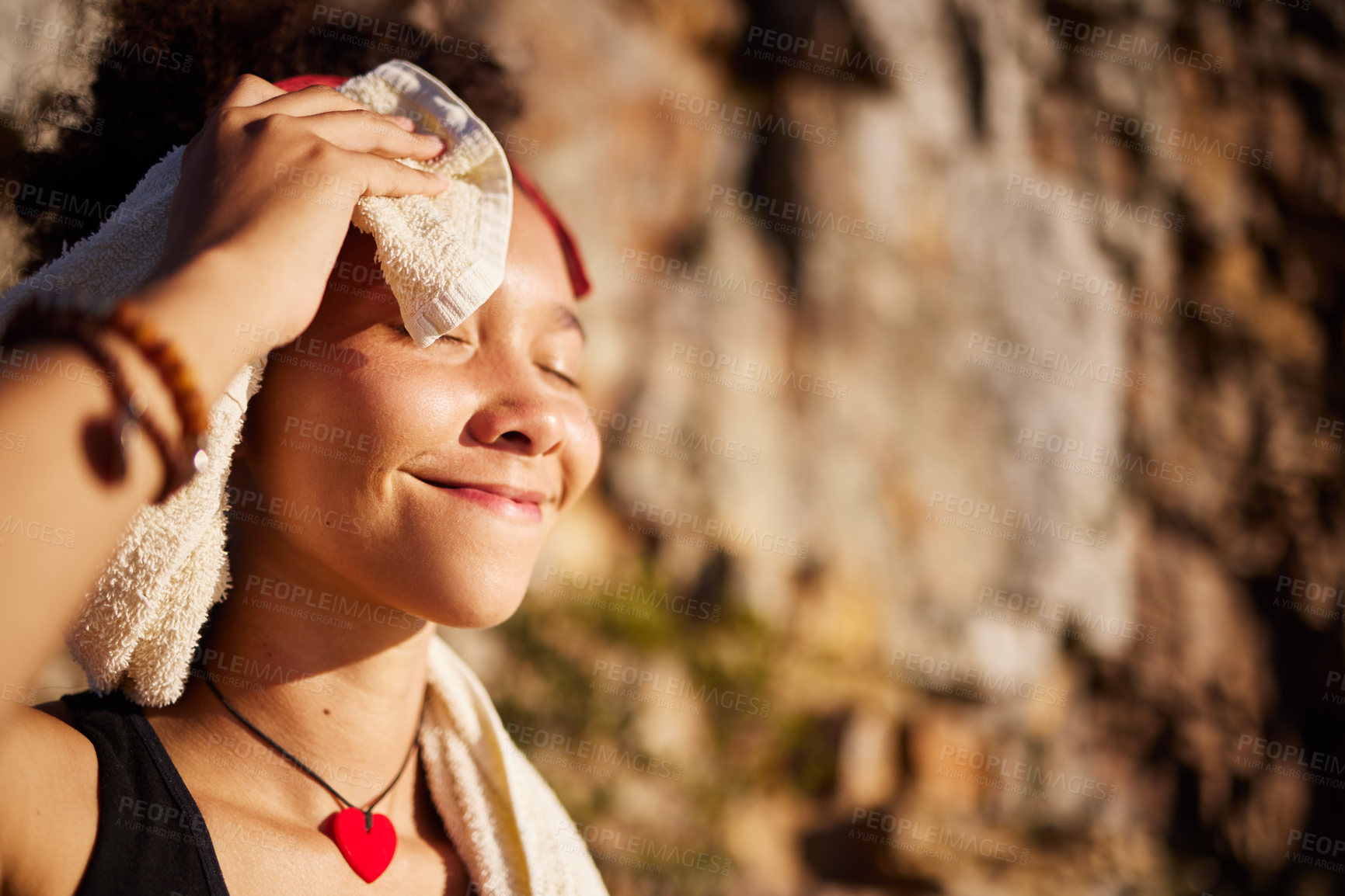 Buy stock photo Shot of a woman using a towel to dry herself after a workout