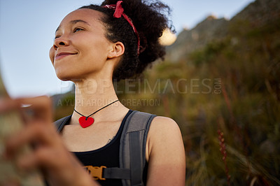 Buy stock photo Shot of a woman looking happy while out on a hike