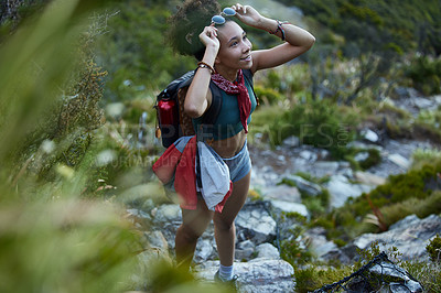 Buy stock photo Shot of a young woman out for a hike in the mountains