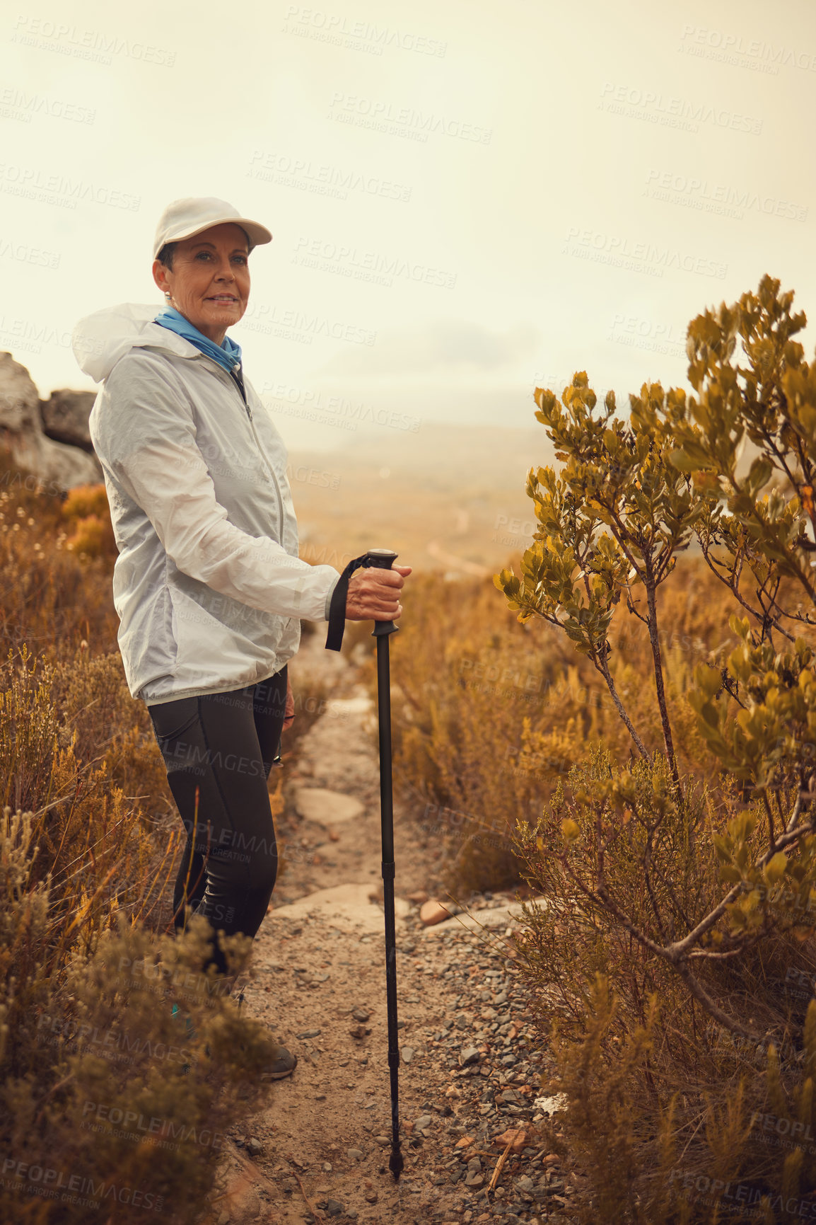 Buy stock photo Trekking pole, hiking and travel with portrait of old woman in nature for wellness, fitness and retirement. Journey, freedom and senior hiker walking in outdoors for environment, adventure or sunrise