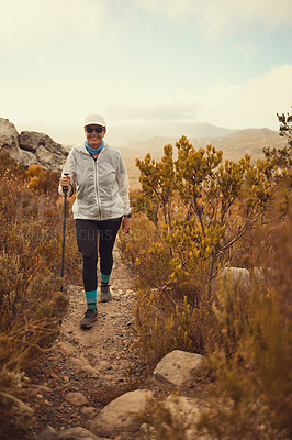 Buy stock photo Shot of a mature woman hiking in nature