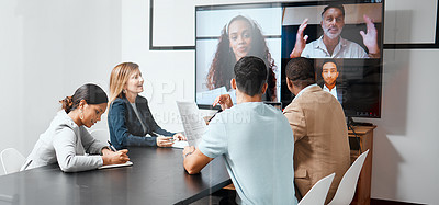 Buy stock photo Cropped shot of a diverse group of businesspeople sitting in the boardroom during a meeting with their international colleagues via video chat