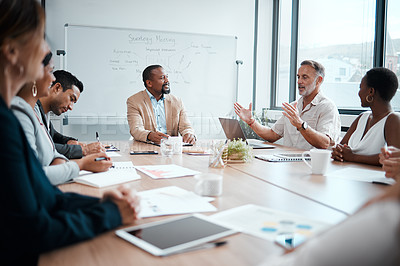 Buy stock photo Shot of a group of staff listening to their boss during a business meeting