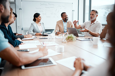 Buy stock photo Shot of a group of staff listening to their boss during a business meeting