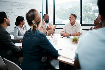 Buy stock photo Shot of a group of businesspeople listening to a colleagues ideas during a meeting