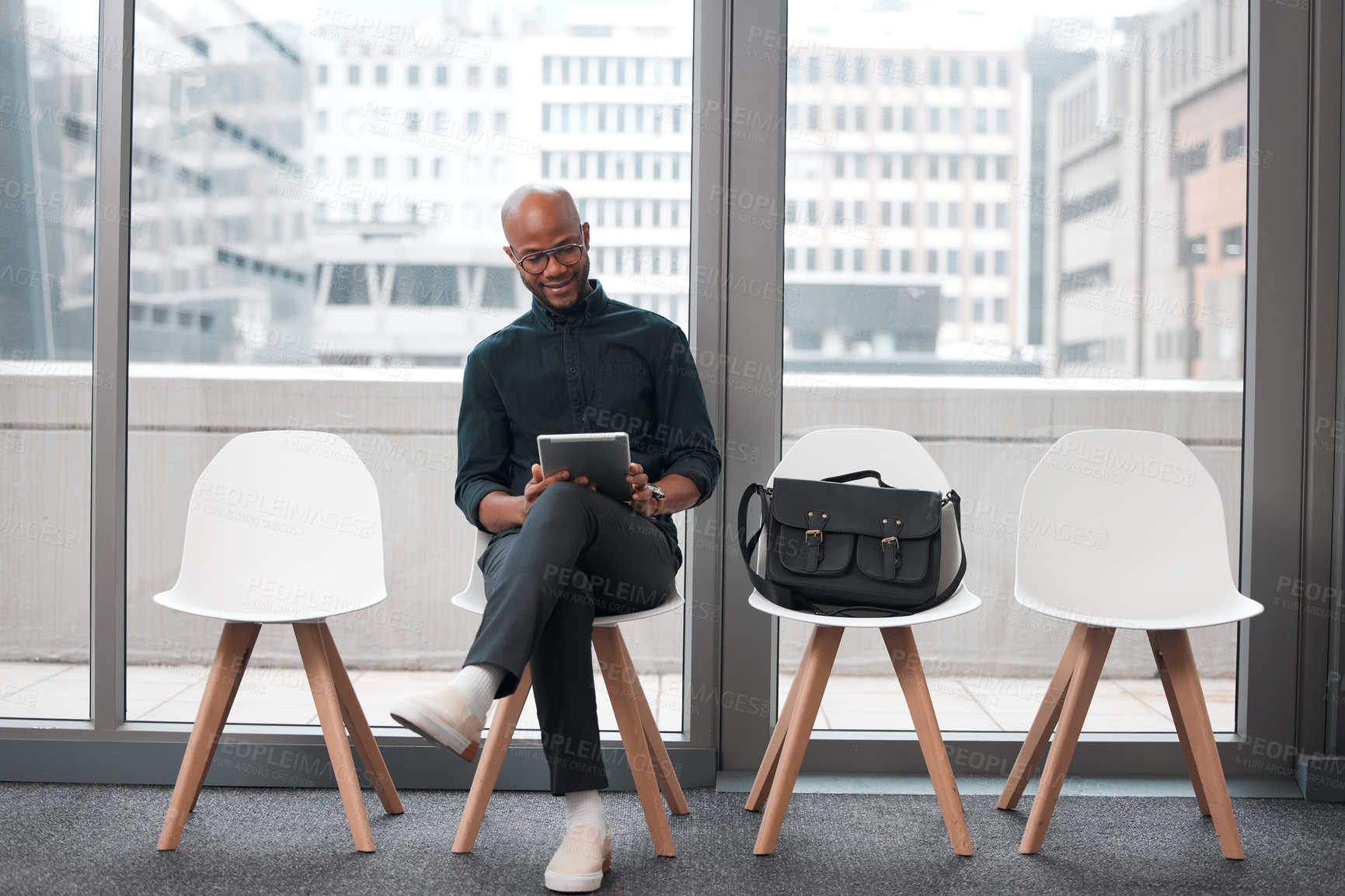 Buy stock photo Business man, tablet and chair in waiting room, queue and opportunity of job interview, recruitment process or human resources. Black male, digital technology and browsing internet in line for hiring