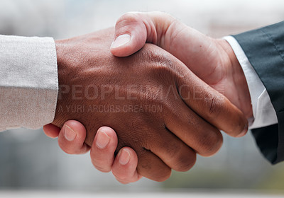Buy stock photo Cropped shot of two unrecognizable businessmen shaking hands while standing in their office
