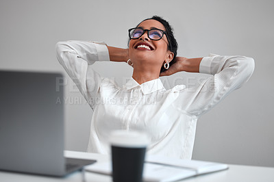 Buy stock photo Cropped shot of an attractive young businesswoman looking relaxed with her hands behind her head at a desk in the office