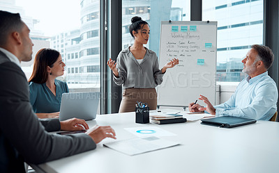 Buy stock photo Shot of a young businesswoman giving a presentation to her colleagues in an office