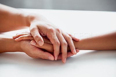 Buy stock photo Hands, support and hope for comfort or care on table, reassurance or empathy for bad news or illness. Closeup, friends and unity in crisis by prayer, trust or bond for person suffering with diagnosis
