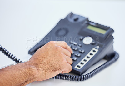 Buy stock photo Shot of a businessman using a telephone to make a call