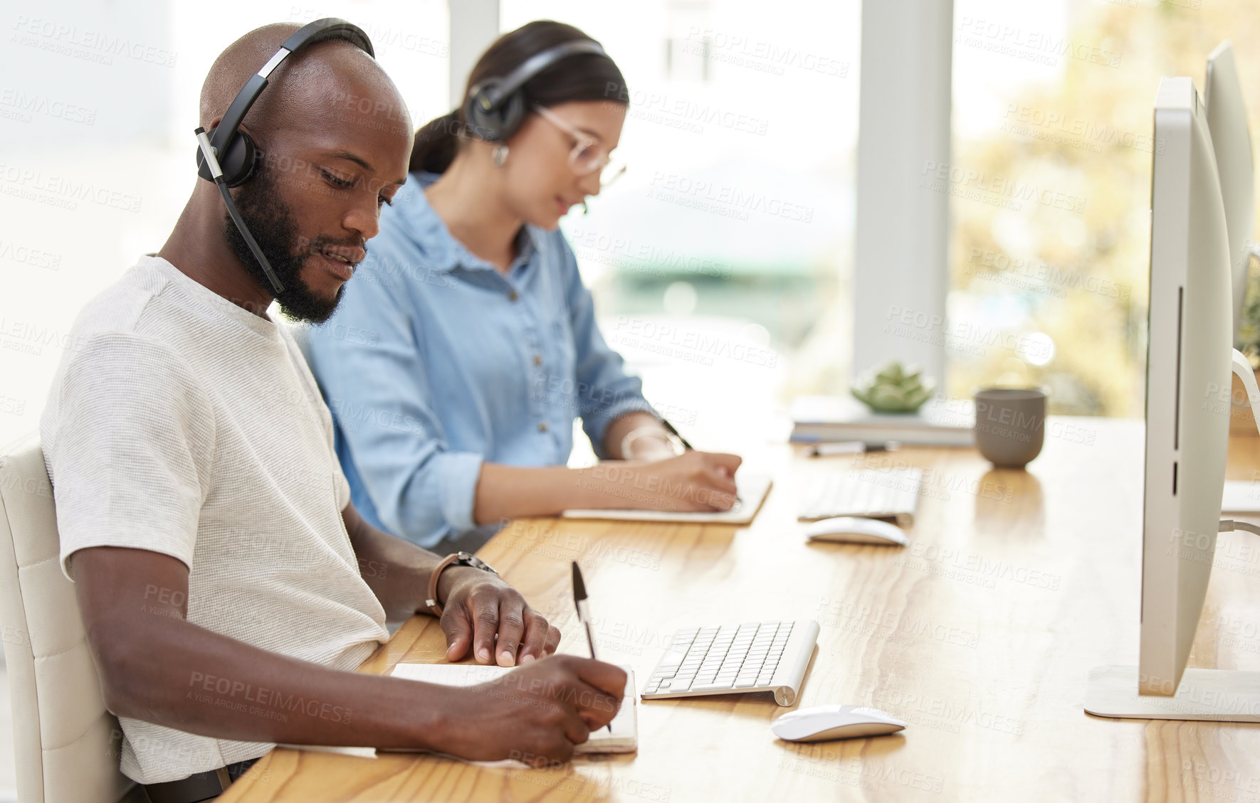 Buy stock photo Shot of two call center workers together