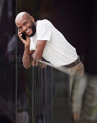 Buy stock photo Shot of a young businessman taking a break to use his smartphone to make a call