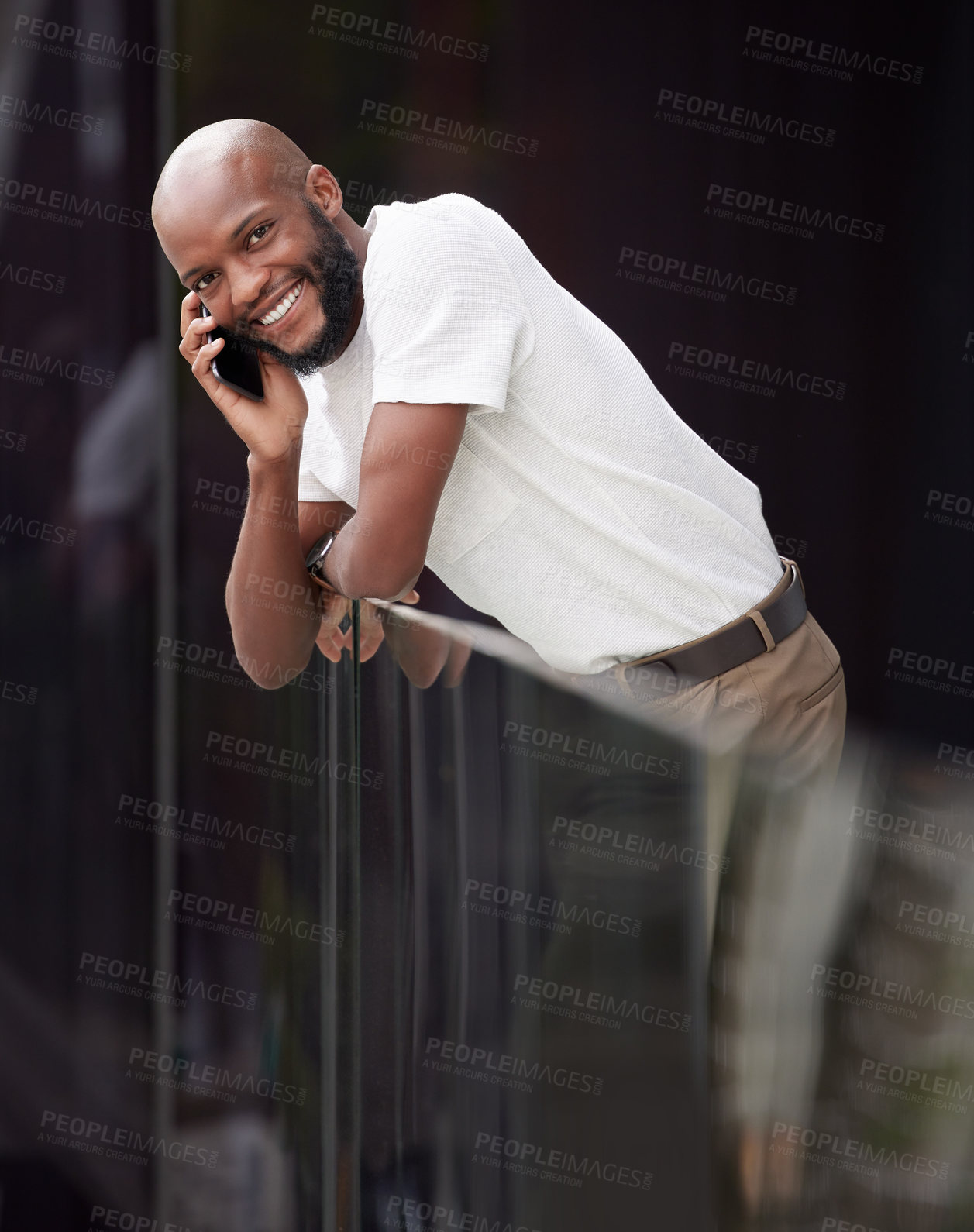 Buy stock photo Shot of a young businessman taking a break to use his smartphone to make a call