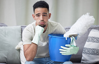 Buy stock photo Stress, depression and man cleaning home for hygiene, health and thinking in living room. Sad person, housework and tired of chores, anxiety or frustrated janitor with bucket on sofa in apartment