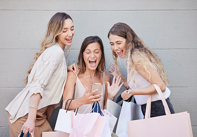 Buy stock photo Cropped shot of three attractive young women taking some time out to enjoy a shopping spree in the city