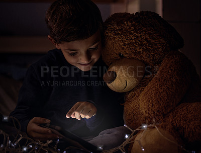 Buy stock photo Tablet, teddy bear and boy child at night watch movie, film or show online for entertainment at home. Relax, dark and young kid streaming video on internet with digital technology in bedroom at house